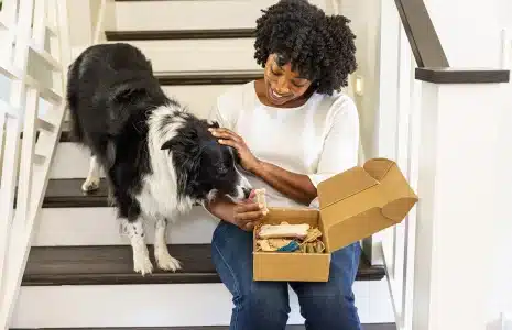 Woman opening a subscription box received from TFE